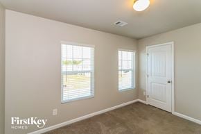 Dallas house for rent - a bedroom with a white door and two windows