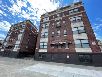 East Orange apartment for rent - A red brick building with a sign that says "International Properties".