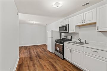 Philadelphia apartment for rent - A kitchen with white cabinets and a wooden floor.