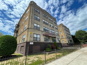 East Orange apartment for rent - A large brick building with a sign that says "Lemon Grove Apartments".