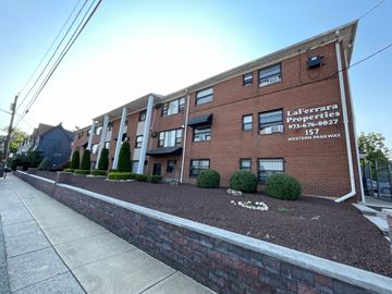 Irvington apartment for rent - A brick building with a sign that says LaFerrara Properties.