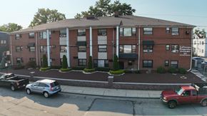 Irvington apartment for rent - A red truck is parked on the street in front of a building.