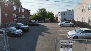 Irvington apartment for rent - A parking lot with cars and a sign that says "No Parking Any Time".