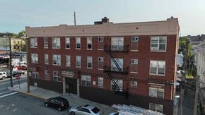 Irvington apartment for rent - A red brick building with a sign that says "Learnco's".