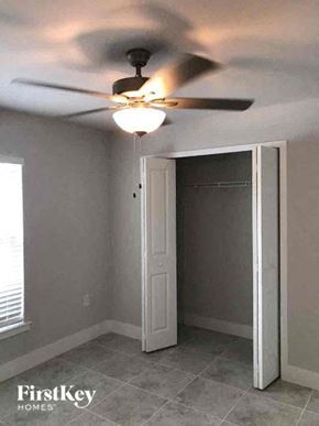 Fort Myers house for rent - a bedroom with a ceiling fan and a door to a closet