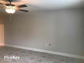 Fort Myers house for rent - a living room with a ceiling fan and a tiled floor