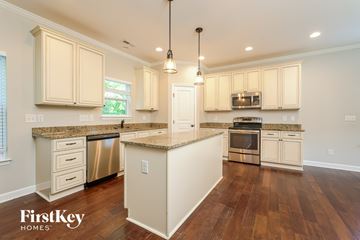 Kernersville house for rent - A kitchen with wooden floors and a center island.