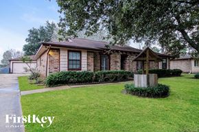 Friendswood house for rent - a small brick house with a yard and a tree