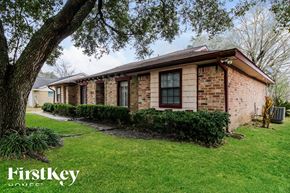 Friendswood house for rent - a brick house with a tree in the yard