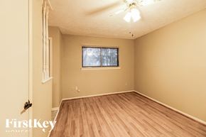 Friendswood house for rent - the living room of an empty house with wood floors and a window