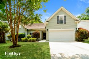 Summerville house for rent - a house with a white garage door and a lawn