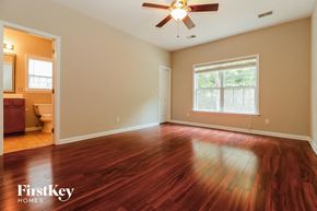 Summerville house for rent - the living room with hardwood flooring and a ceiling fan
