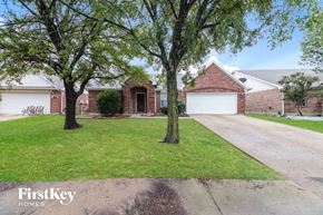 Forney house for rent - a house with a lawn and trees in front of it