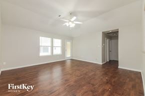 Forney house for rent - an empty living room with wood flooring and a ceiling fan