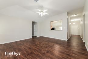 Forney house for rent - a living room with a hard wood floor and a ceiling fan