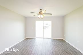 Leesburg house for rent - A room with a ceiling fan and wooden flooring.