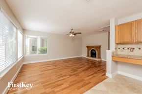 Humble house for rent - a living room with a fireplace and a wooden floor
