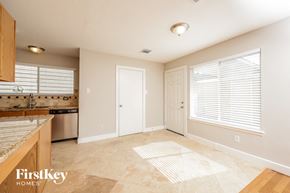 Humble house for rent - an empty kitchen and living room with a large window