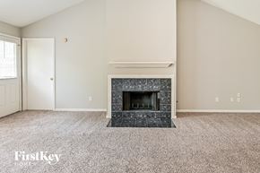 Katy house for rent - the living room has a fireplace and carpeted flooring