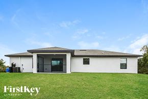 Lehigh Acres house for rent - a white house with a grassy yard