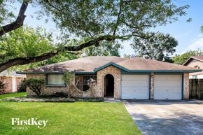 Spring house for rent - A house with a green roof and a garage door is for sale.