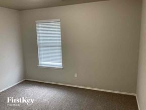 Rockwall house for rent - A room with a window and a carpeted floor.