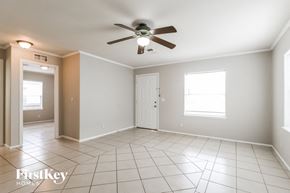 Tomball house for rent - A spacious room with a ceiling fan and tiled flooring.
