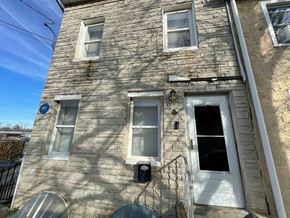 Chester apartment for rent - A stone building with a white door and windows.