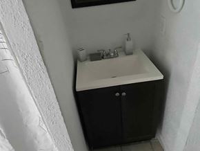 Chester apartment for rent - A white sink with a black cabinet below it.