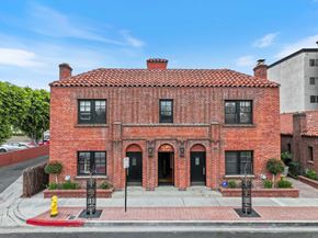 Fullerton apartment for rent - A red brick house with a black door and windows.