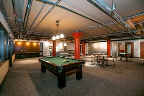 Kansas City apartment for rent - a room with a pool table in the middle of it