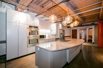 Kansas City apartment for rent - a large kitchen with white cabinets and a marble counter top
