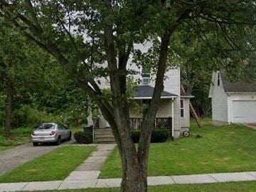 Warren house for rent - A tree in front of a white house with a car parked on the street.