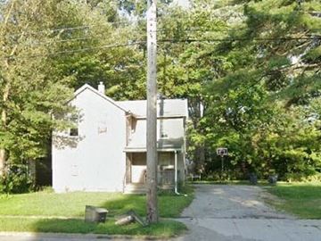 Warren house for rent - A white house is surrounded by trees and a grassy area.