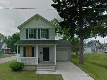 Warren house for rent - A house with a boarded up window.