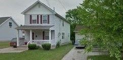 Warren house for rent - A white house with a red stripe on the window shutters.