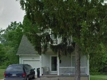 Warren house for rent - A white house with a blue car parked in front.