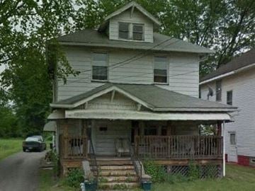 Warren house for rent - A white house with a porch and a car parked in front.