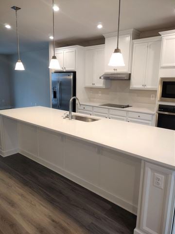 Laurel house for rent - a kitchen with a white counter top and a sink