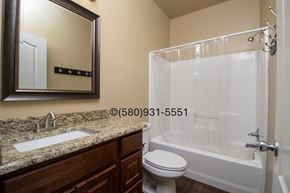 Durant apartment for rent - A bathroom with a sink, toilet, and bathtub.