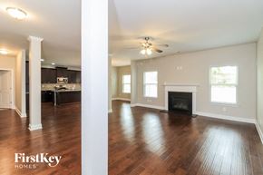 Villa Rica house for rent - an empty living room with wood floors and a fireplace