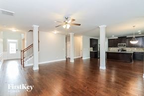 Villa Rica house for rent - an empty living room and kitchen with a ceiling fan