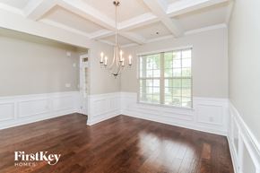 Villa Rica house for rent - an empty dining room with a chandelier and a window