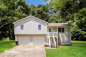 Canton house for rent - a white house with two garage doors and a staircase