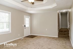Canton house for rent - a living room with a ceiling fan and a staircase