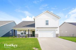 Clarksville house for rent - a white house with a white garage door and a lawn