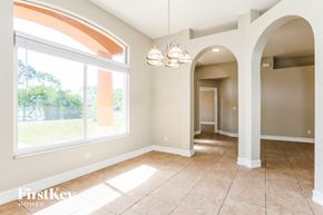 Lehigh Acres house for rent - a dining room with a large window and a tiled floor