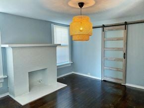 Forth Worth apartment for rent - a living room with a fireplace and a sliding barn door