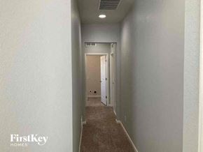 Aurora house for rent - a hallway with a carpet and a door to a room