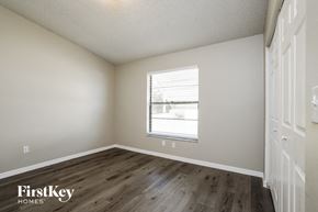 Cape Coral house for rent - a bedroom with a window and wooden floors